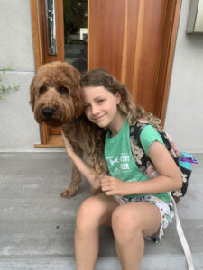 Whoodle dog with young girl